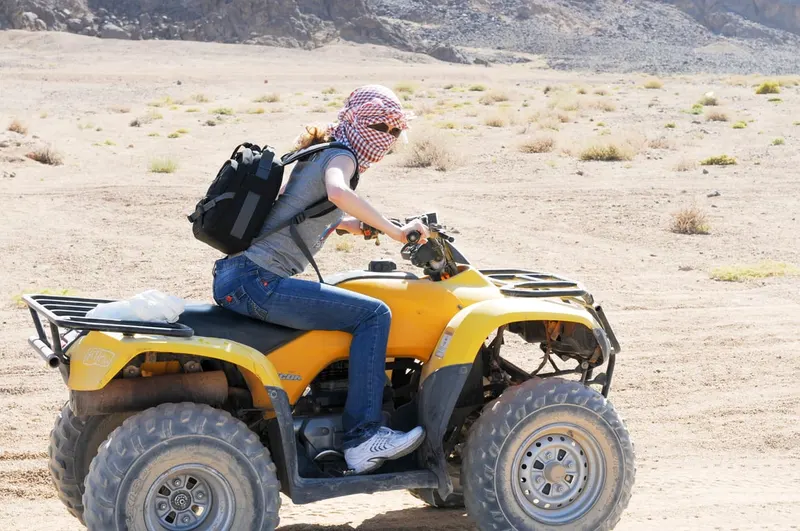Girl rides atv in the desert